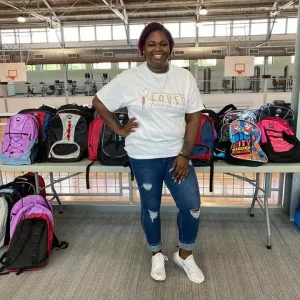 Tamesha Brown with backpacks from Back to School Drive